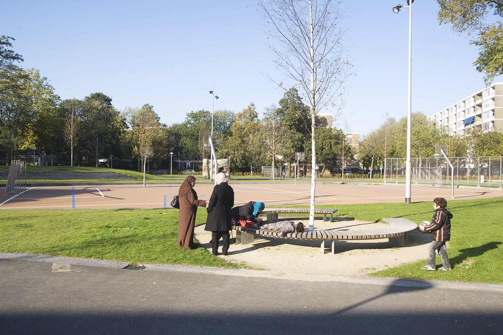 Tree benches and a lowered sporting field